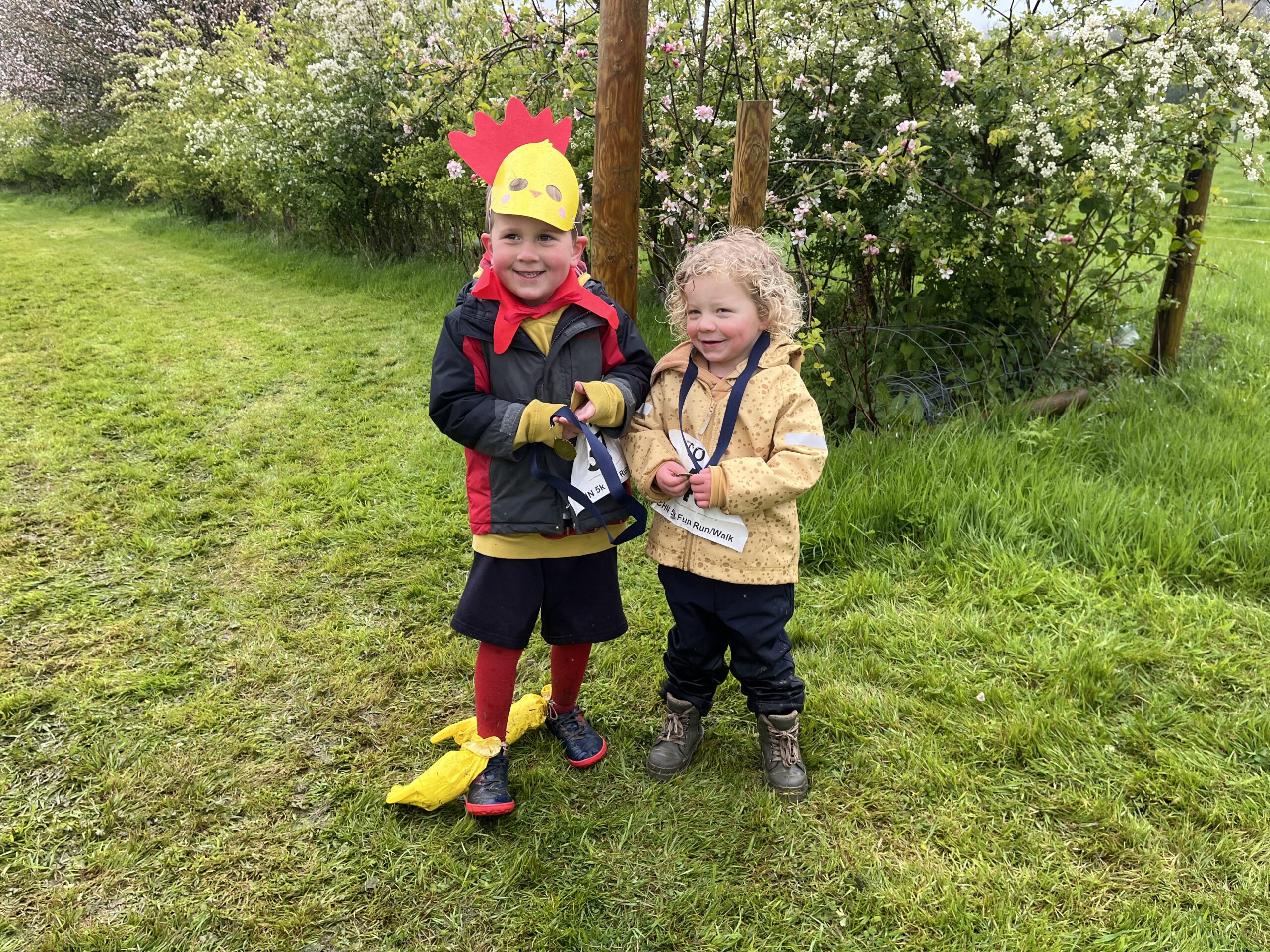 Two children with their Chicken Run medals